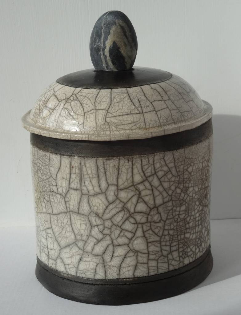 Raku jar with stone handle
